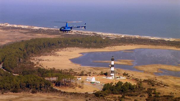 Coastal Helicopters R-44 flys past Bodie Island Light - Photo from CH web site